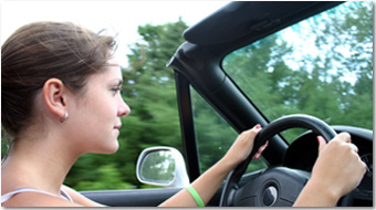 Teenaged girl behind the wheel of car
